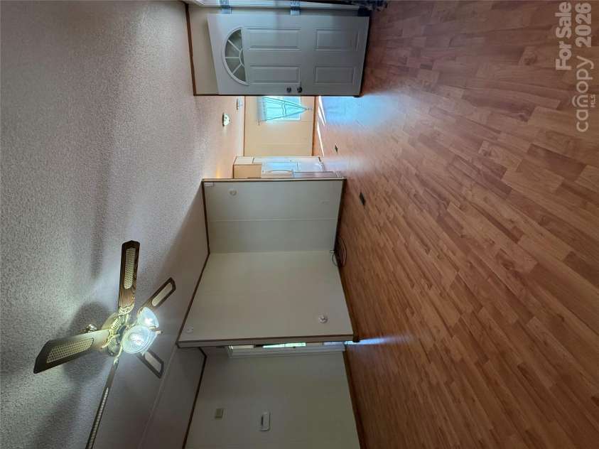 97 Fair Haven Drive, Burnsville, NC 28714.  MLS# CAR4433104, YatesRealty ID 56186. Living room looking into kitchen