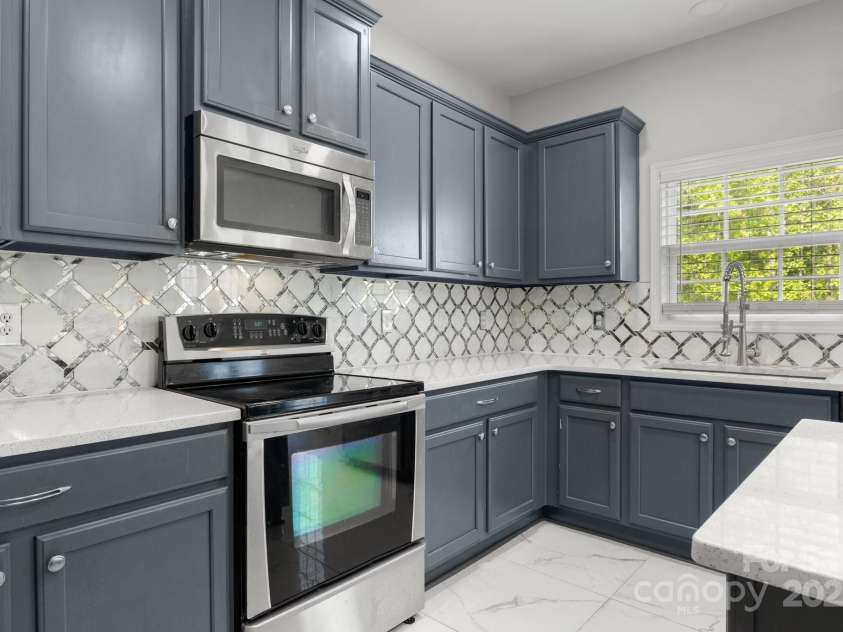 8453 Mossy Cup Trail, Harrisburg, NC 28075.  MLS# CAR4245368, YatesRealty ID 5619. Beautiful custom backsplash and ss appliances