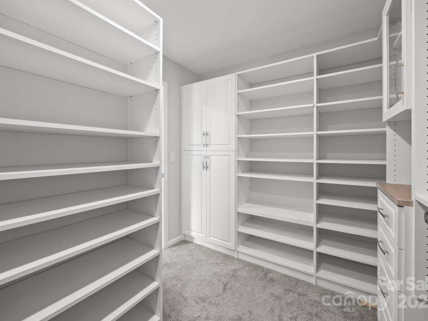 8453 Mossy Cup Trail, Harrisburg, NC 28075.  MLS# CAR4245368, YatesRealty ID 5619. Custom built ins in primary closet off of bathroom