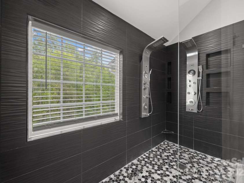 8453 Mossy Cup Trail, Harrisburg, NC 28075.  MLS# CAR4245368, YatesRealty ID 5619. Custom tile and shower heads with frameless glass
