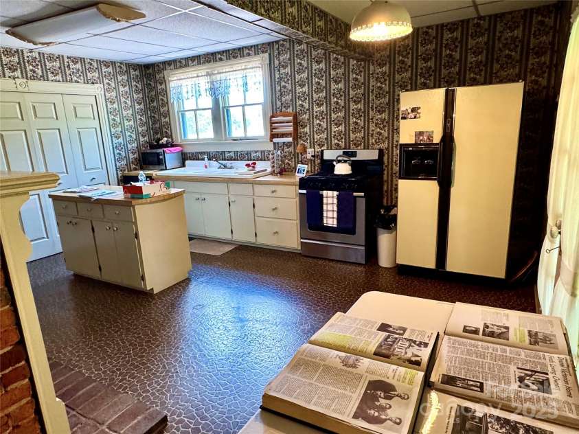 4689 Lakeview Acres Road, Valdese, NC 28690.  MLS# CAR4260635, YatesRealty ID 562. The kitchen has its own fireplace, a large pantry,  and lots of space