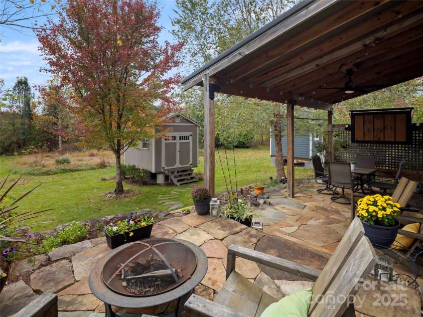 32 Bungalow Way, Brevard, NC 28712.  MLS# CAR4330127, YatesRealty ID 5624. Back Flagstone patio, with fire pit area