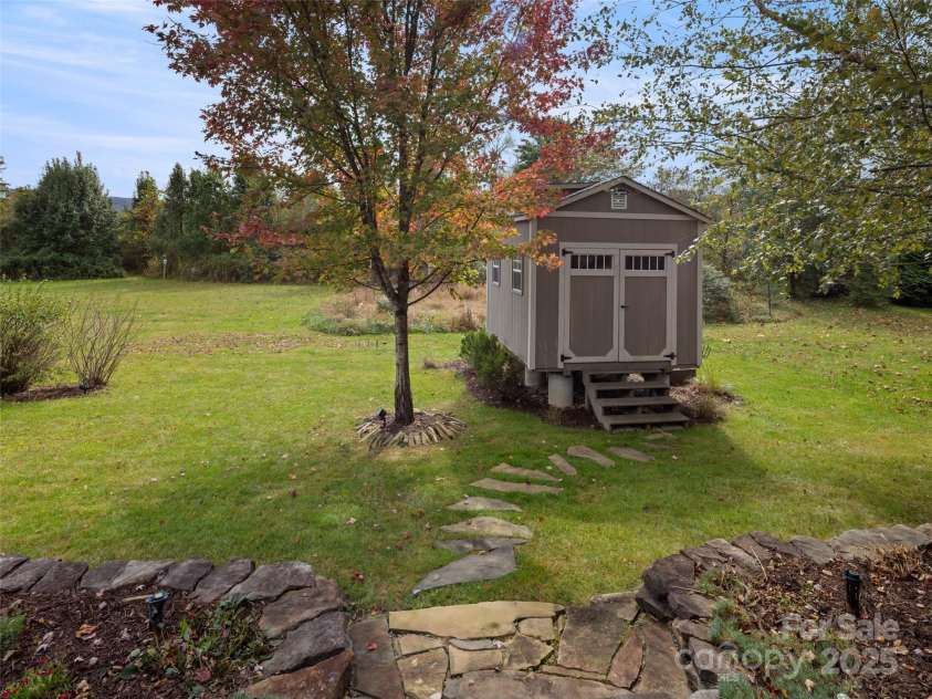 32 Bungalow Way, Brevard, NC 28712.  MLS# CAR4330127, YatesRealty ID 5624. Storage shed in back