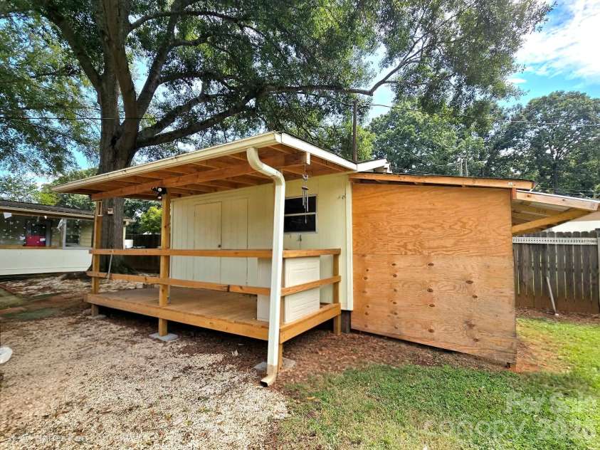 4107 Windwood Drive, Gastonia, NC 28056.  MLS# CAR4433892, YatesRealty ID 56264. Storage building with a covered porch and lean-to addition