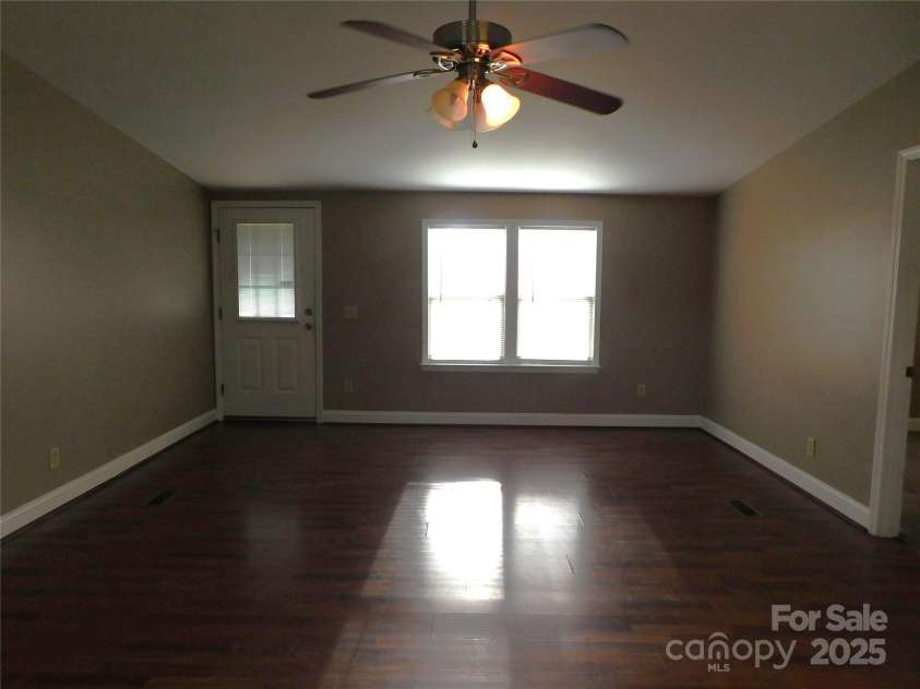 1909 Lawyers Road, Monroe, NC 28110.  MLS# CAR4234355, YatesRealty ID 5627. Living room view from kitchen