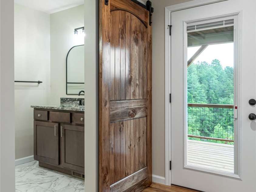 181 Flint Morgan Road, Mars Hill, NC 28754.  MLS# CAR4288459, YatesRealty ID 5628. Primary Suite features private access to back deck