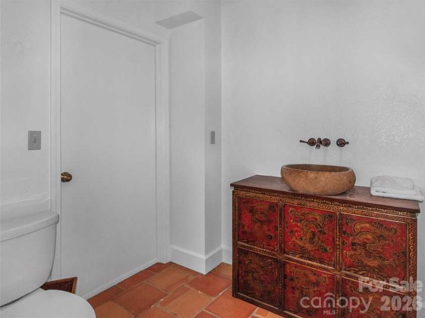 2222 Greenspire Drive, Sylva, NC 28779.  MLS# CAR4159278, YatesRealty ID 5629. Half Bath-Main Level with antique vanity.
