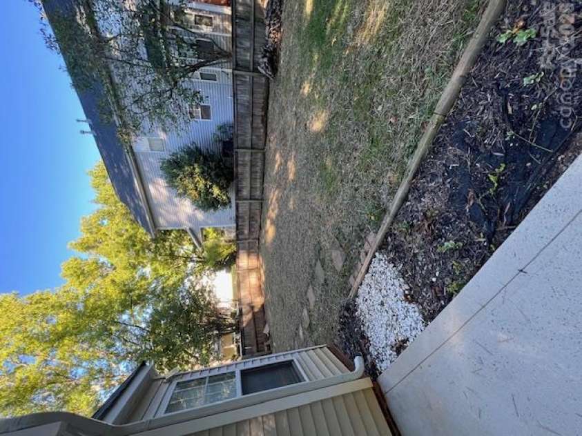 21411 Aftonshire Drive, Cornelius, NC 28031.  MLS# CAR4433846, YatesRealty ID 56299. Side yard