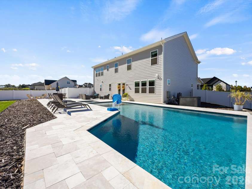 1305 Coppergate Drive, Salisbury, NC 28147.  MLS# CAR4428820, YatesRealty ID 56314. Travertine patio surrounds pool and spa