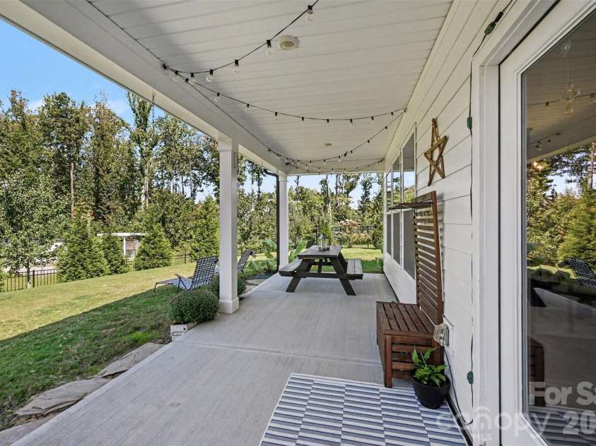 2703 Wedgewood Court, Denver, NC 28037.  MLS# CAR4428262, YatesRealty ID 56317. A long covered back porch with string lights, ready for evenings outside.