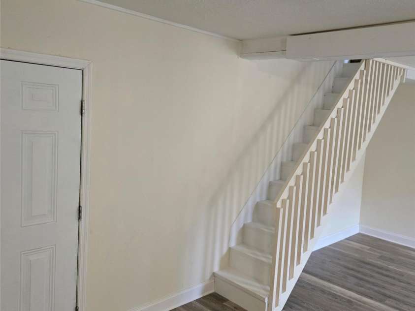 461 Tweed Road, Madison, NC 28753.  MLS# CAR4267871, YatesRealty ID 564. Paneling removed and stair rail exposed and painted