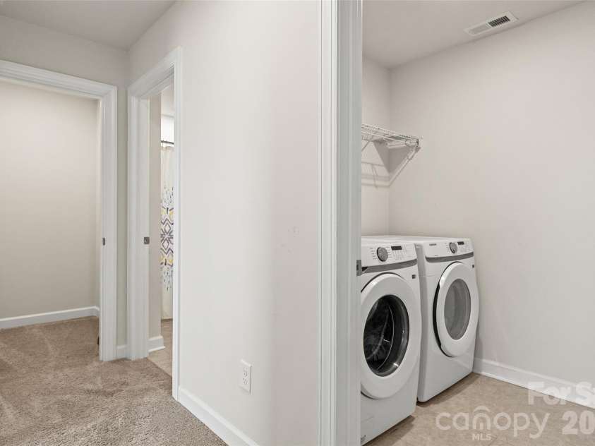 333 Hyssop Court, Fort Mill, SC 29715.  MLS# CAR4434309, YatesRealty ID 56420. Second floor hallway featuring laundry room and large storage closet