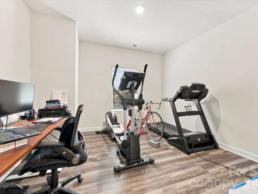 7722 Porrera Street, Charlotte, NC 28214.  MLS# CAR4434037, YatesRealty ID 56499. Flex space with LVP flooring.