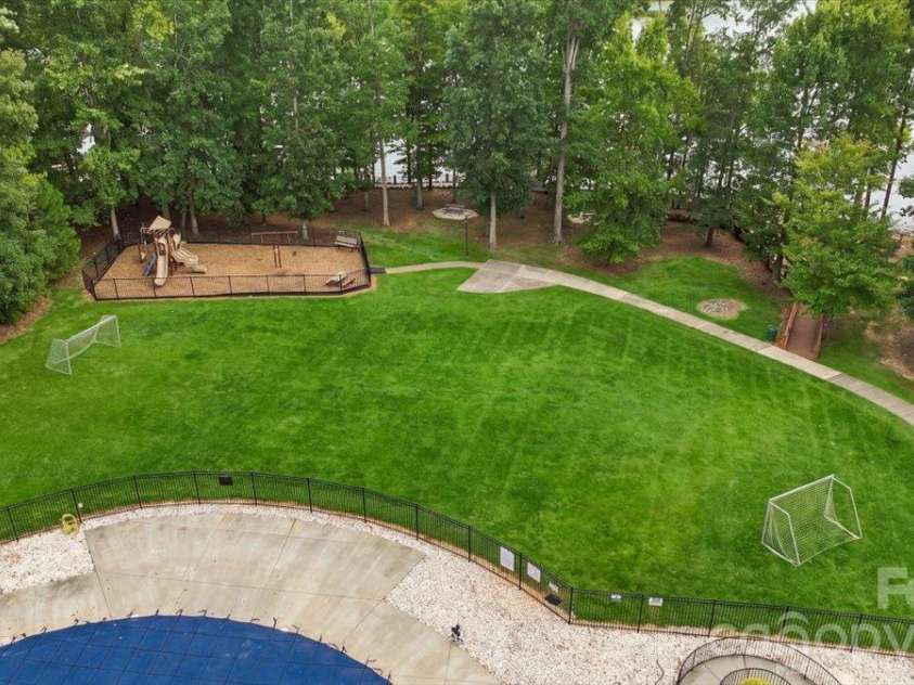 7722 Porrera Street, Charlotte, NC 28214.  MLS# CAR4434037, YatesRealty ID 56499. Playground located lake front.