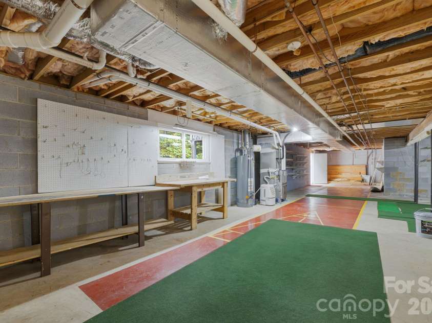 103 Tarragon Place, Flat Rock, NC 28731.  MLS# CAR4432456, YatesRealty ID 56509. Workshop area in basement