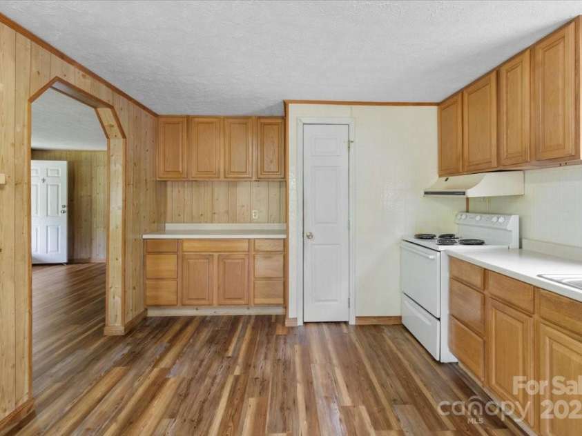 461 Tweed Road, Madison, NC 28753.  MLS# CAR4267871, YatesRealty ID 5652. Kitchen opens onto deck