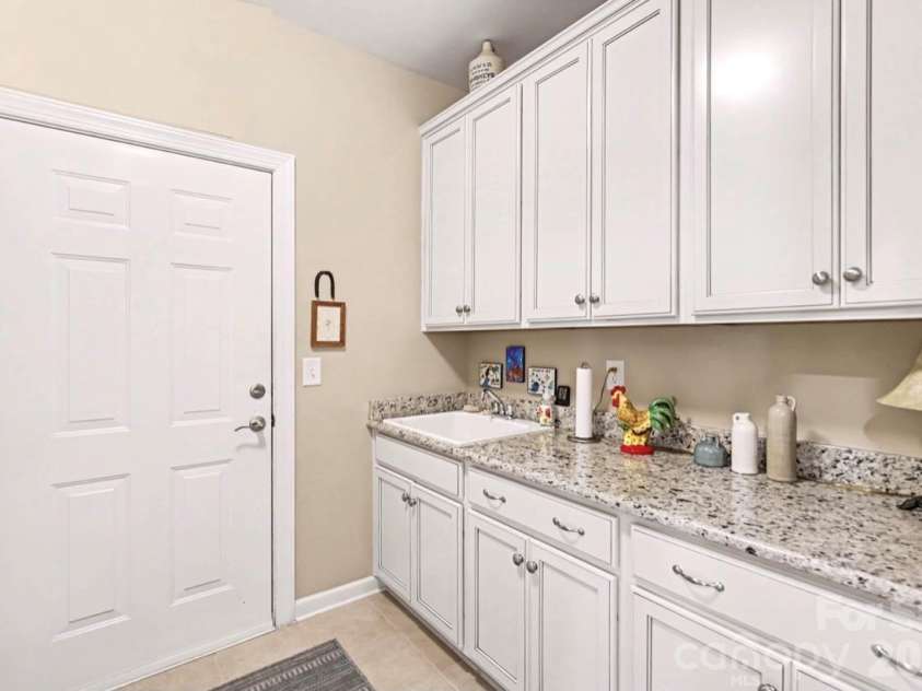 1567 Tranquility Boulevard, Lancaster, SC 29720.  MLS# CAR4433825, YatesRealty ID 56650. Utility Sink and Extra Cabinets in Laundry Room