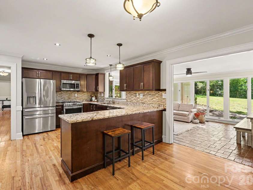 607 Anderson Avenue, Salisbury, NC 28144.  MLS# CAR4429021, YatesRealty ID 56703. Rich cabinetry, stainless steel appliances, and a spacious breakfast bar complement a kitchen that opens to a bright sunroom.