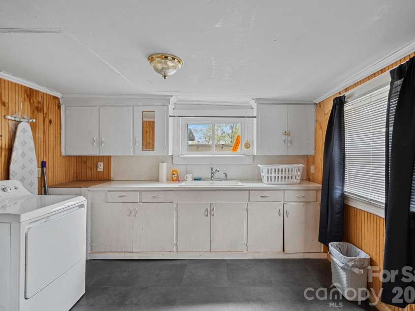 74 Meadow Avenue, Concord, NC 28025.  MLS# CAR4355867, YatesRealty ID 5679. Laundry room with cabinets and sink