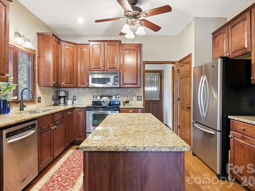 1669 Aragon Beach Road, Rock Hill, SC 29732.  MLS# CAR4429104, YatesRealty ID 56795. Kitchen with center island, granite counters, SS appliances, and compactor