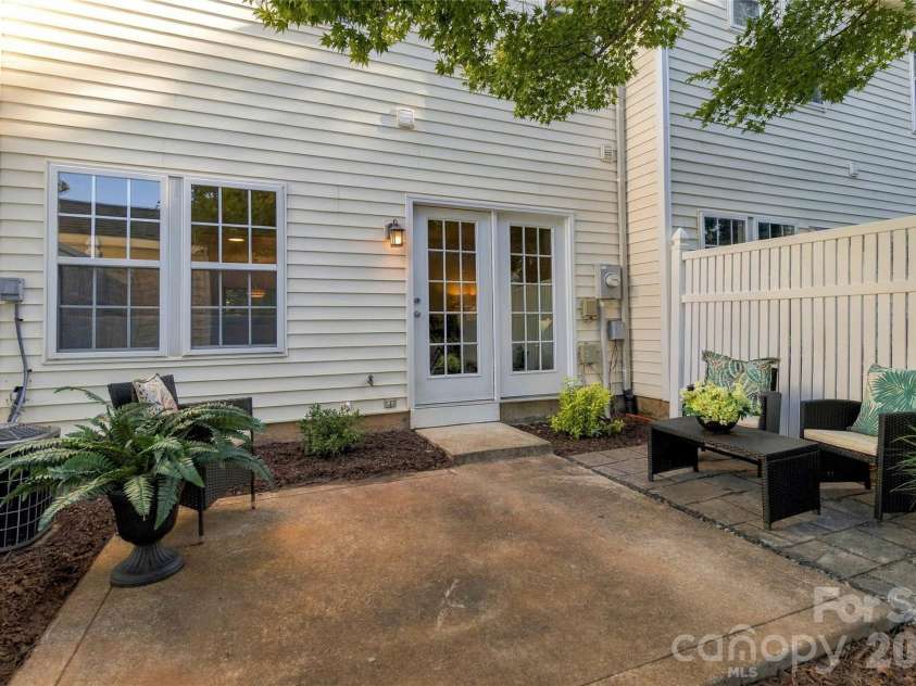 18631 Oakhurst Boulevard, Cornelius, NC 28031.  MLS# CAR4435092, YatesRealty ID 56861. Fresh mulch and shrubs surround patio
