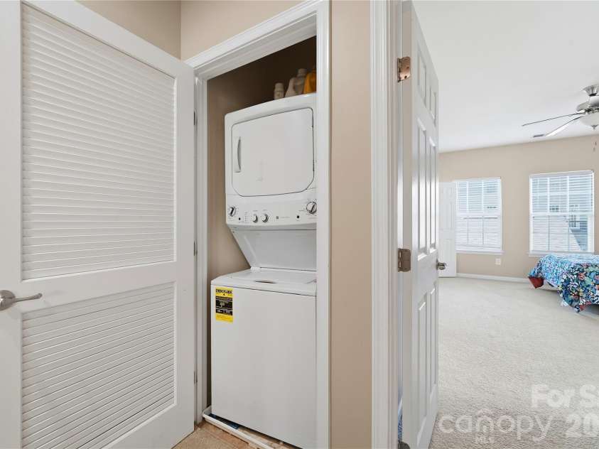 19862 Lamp Lighters Way, Cornelius, NC 28031.  MLS# CAR4430703, YatesRealty ID 56901. Closet with stackable washer & dryer at 19862 Lamp Lighters Way at Antiquity in Cornelius.