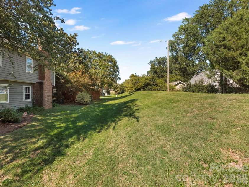 727 Clayfield Court, Charlotte, NC 28209.  MLS# CAR4434507, YatesRealty ID 56924. Berm behind house