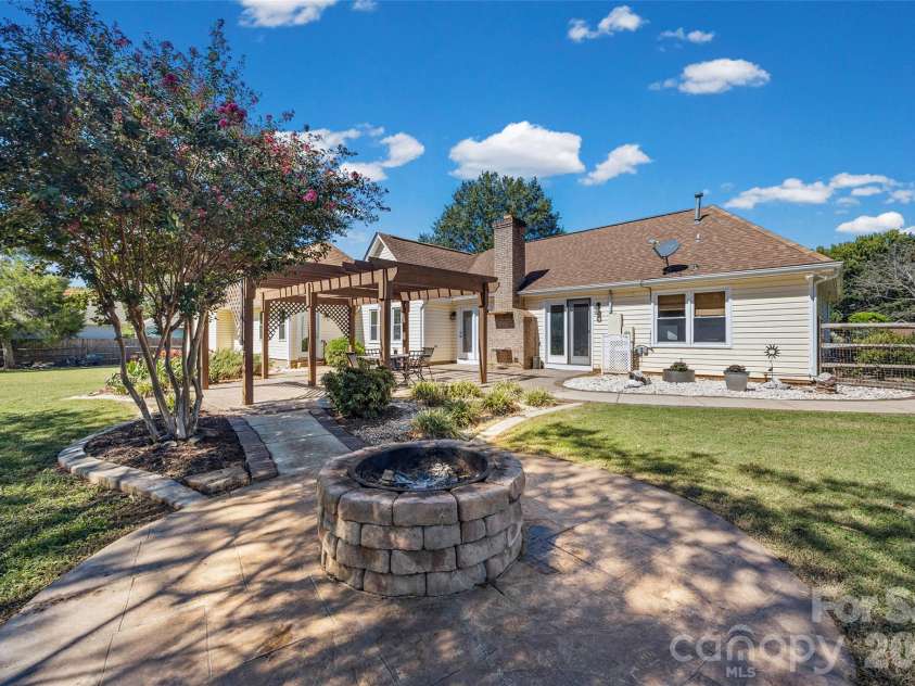 3117 Monte Drive, Monroe, NC 28110.  MLS# CAR4434474, YatesRealty ID 56942. Fire pit overlooking back patio