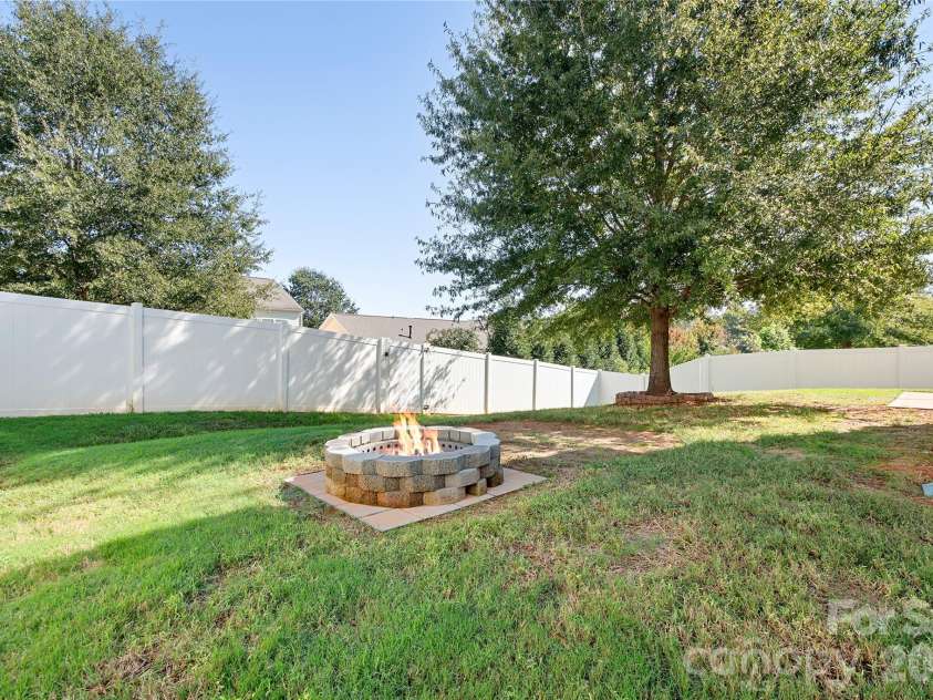 117 Abel Peterson Drive, Mount Holly, NC 28120.  MLS# CAR4433396, YatesRealty ID 56976. Backyard firepit