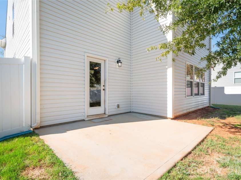 117 Abel Peterson Drive, Mount Holly, NC 28120.  MLS# CAR4433396, YatesRealty ID 56976. Backyard patio