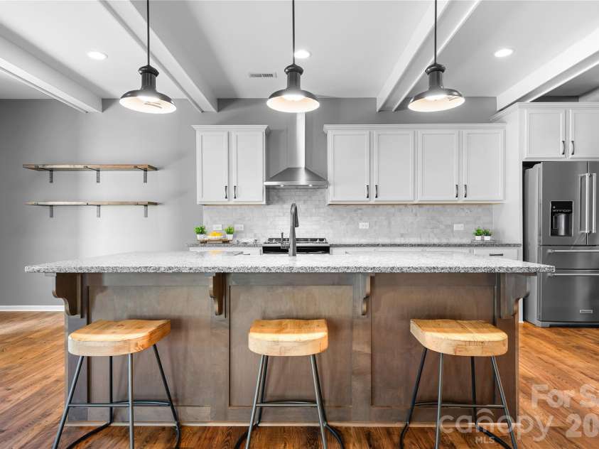 117 Abel Peterson Drive, Mount Holly, NC 28120.  MLS# CAR4433396, YatesRealty ID 56976. Kitchen island with beams