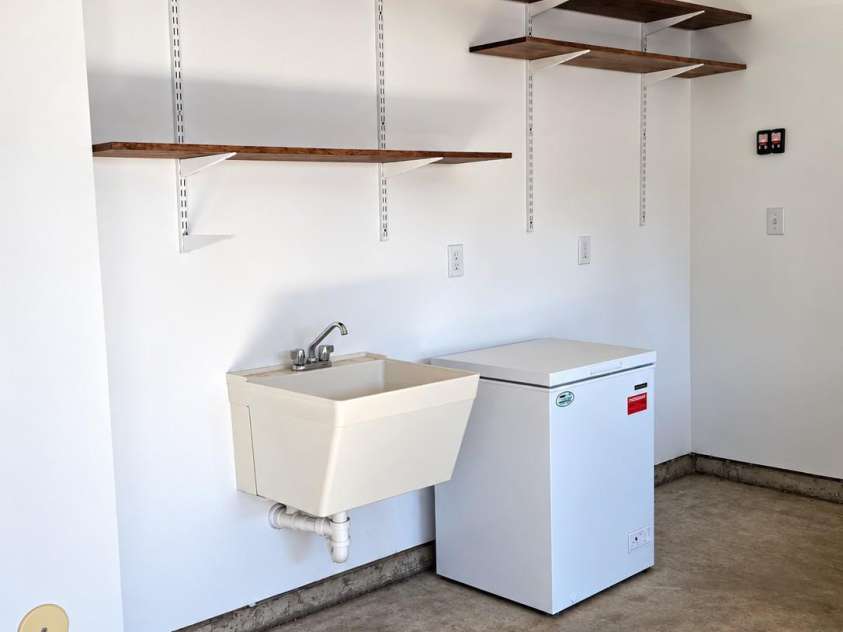 117 Abel Peterson Drive, Mount Holly, NC 28120.  MLS# CAR4433396, YatesRealty ID 56976. Sink & deep freezer in garage