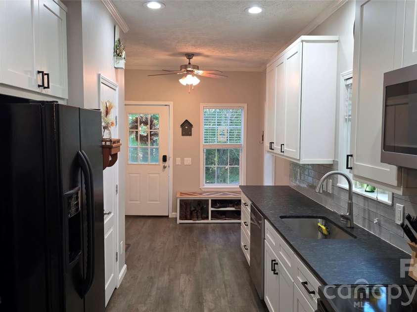 52 Enochs Way Way, Fletcher, NC 28732.  MLS# CAR4432358, YatesRealty ID 56989. Galley Kitchen with Black Granite Countertops
