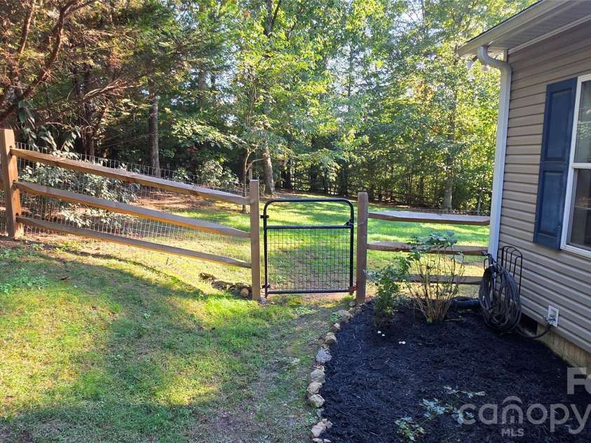 52 Enochs Way Way, Fletcher, NC 28732.  MLS# CAR4432358, YatesRealty ID 56989. Side yard with gate on the for easy access