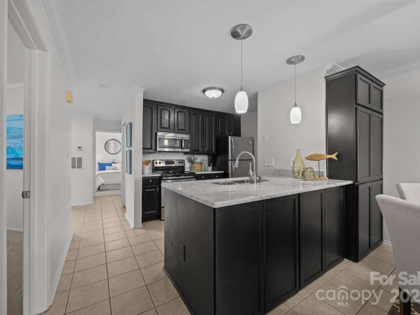 907 Southwest Drive, Davidson, NC 28036.  MLS# CAR4312461, YatesRealty ID 5699. Hidden storage space on dining area side of kitchen island plus large storage cabinet