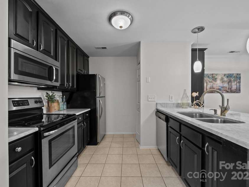 907 Southwest Drive, Davidson, NC 28036.  MLS# CAR4312461, YatesRealty ID 5699. Modern kitchen with marble countertops and stainless steel appliances 