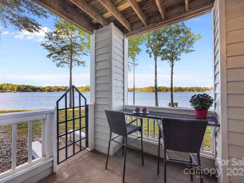 907 Southwest Drive, Davidson, NC 28036.  MLS# CAR4312461, YatesRealty ID 5699. Private and peaceful rear patio. Simply open the patio gate to walk along the shoreline. 