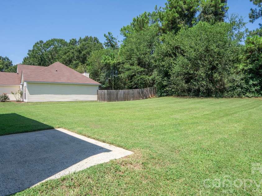 13918 Wild Heather Court, Charlotte, NC 28273.  MLS# CAR4432014, YatesRealty ID 56998. Relaxing Rear Patio Overlooking Tree Lined Backyard