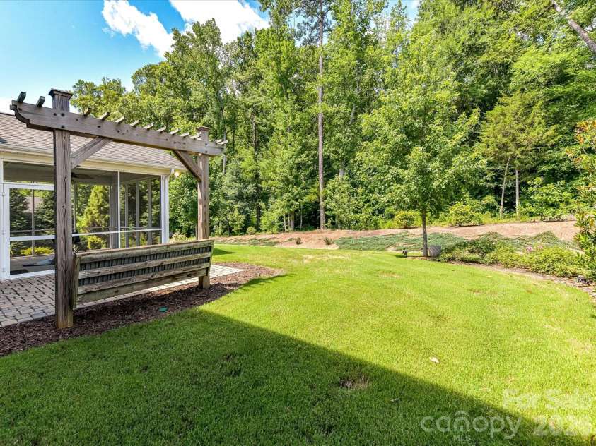 12613 Longford Crossing Place, Huntersville, NC 28078.  MLS# CAR4395393, YatesRealty ID 5708. Enjoy a private, tree-lined backyard retreat featuring lush landscaping, a spacious lawn, and inviting outdoor living spaces perfect for relaxing, entertaining, or enjoying nature year-round.