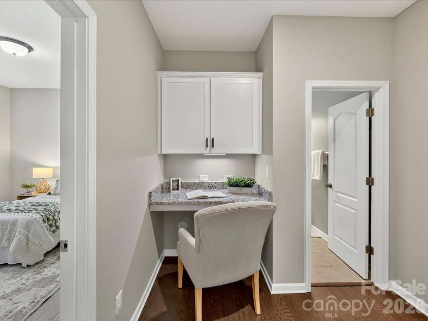 12613 Longford Crossing Place, Huntersville, NC 28078.  MLS# CAR4395393, YatesRealty ID 5708. The built-in workspace provides a convenient and functional area for remote work, studying, or managing daily tasks, complete with upper cabinetry for added storage and organization.