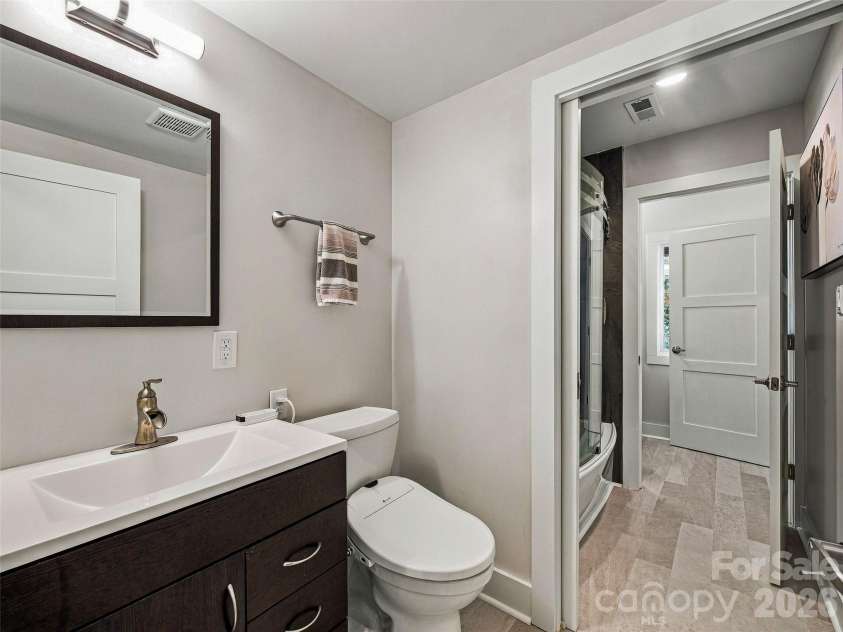 21 Peach Knob Drive, Asheville, NC 28804.  MLS# CAR4435411, YatesRealty ID 57132. Shared bath on the lower level with two private half baths