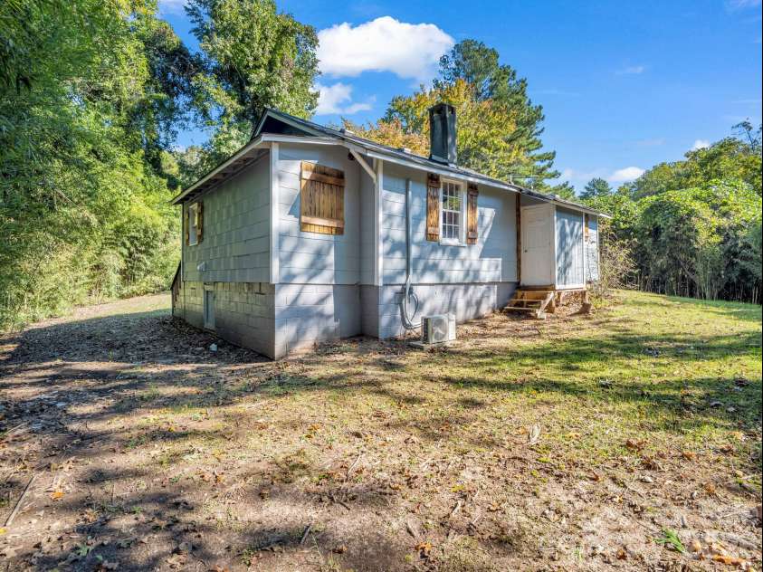 51 Shepherd Street, Tryon, NC 28782.  MLS# CAR4434123, YatesRealty ID 57136. Crawl space entrance on the left