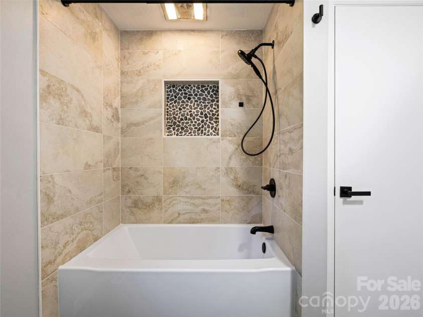 133 Kent Lane, Hendersonville, NC 28739.  MLS# CAR4433472, YatesRealty ID 57156. Second Bathroom with Soaking Tub and Updated Tile