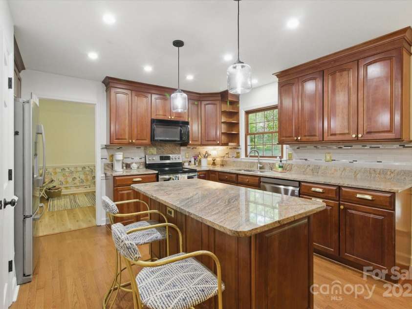 7514 Pewter Lane, Charlotte, NC 28270.  MLS# CAR4244658, YatesRealty ID 5718. The kitchen connects to the dining room and is the central space of the home.