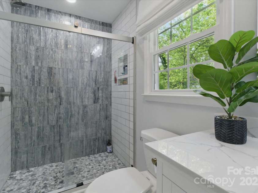 7514 Pewter Lane, Charlotte, NC 28270.  MLS# CAR4244658, YatesRealty ID 5718. The serene tile and fixtures make this bathroom a calming retreat.