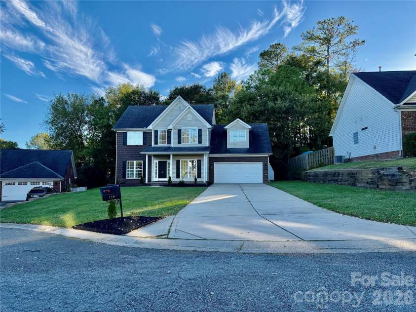116 Huckleberry Lane, Mount Holly, NC 28120.  MLS# CAR4434900, YatesRealty ID 57235. Brick Painted to give it that WOW factor and added black shutters. Front view with long driveway view.  Cul-de-sac lot.