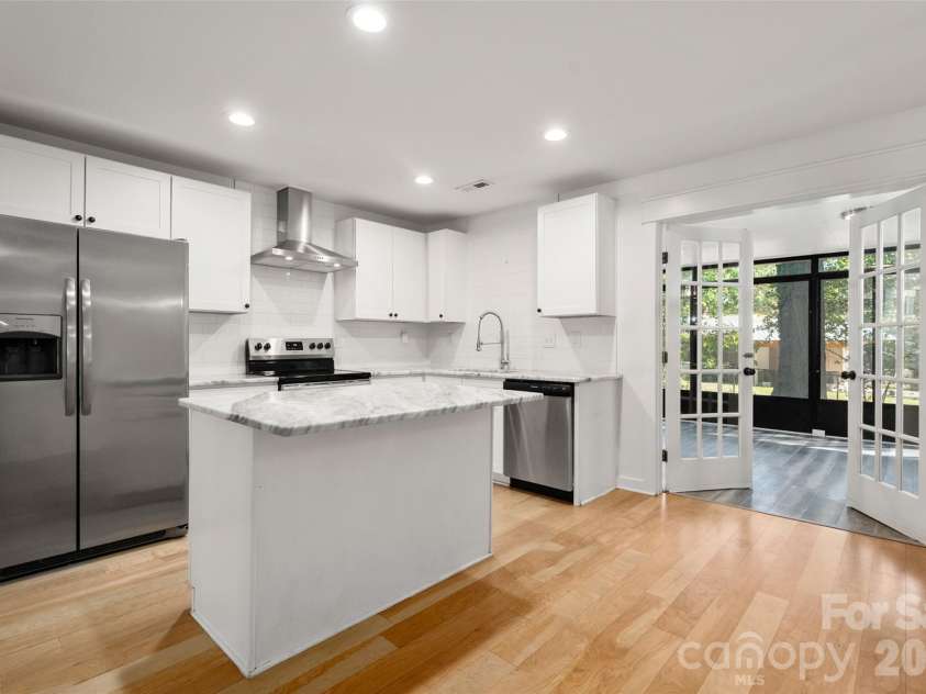 4238 Dowling Drive, Charlotte, NC 28205.  MLS# CAR4434485, YatesRealty ID 57237. Bright white kitchen with island
