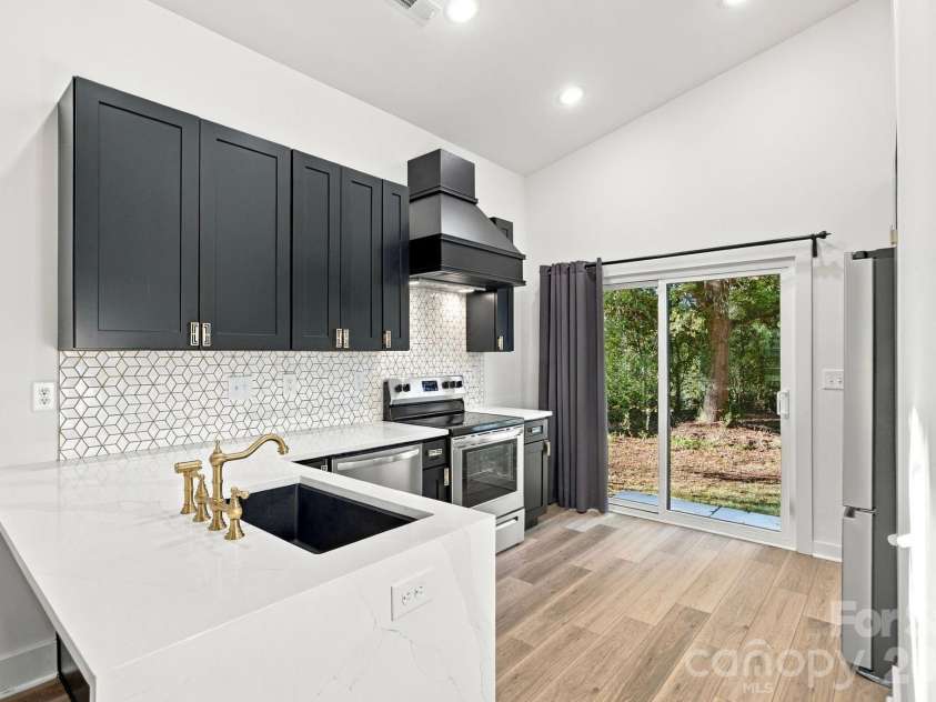 571 Buford Drive, Concord, NC 28025.  MLS# CAR4434170, YatesRealty ID 57269. Kitchen with breakfast bar and sliding doors to the backyard