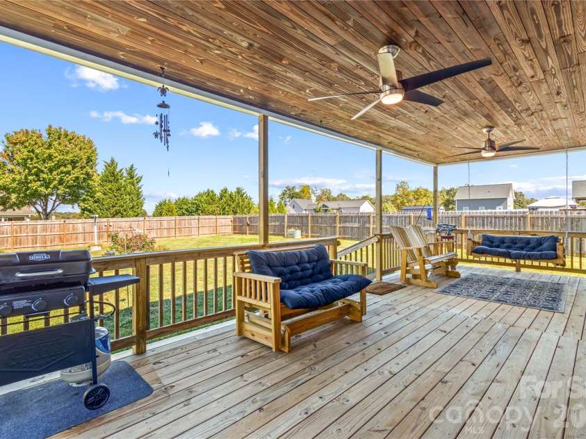 124 Tranquility Lane, Harmony, NC 28634.  MLS# CAR4434998, YatesRealty ID 57297. Oversized covered back deck with Ceiling Fans, overlooking private back yard complete with privacy fence!