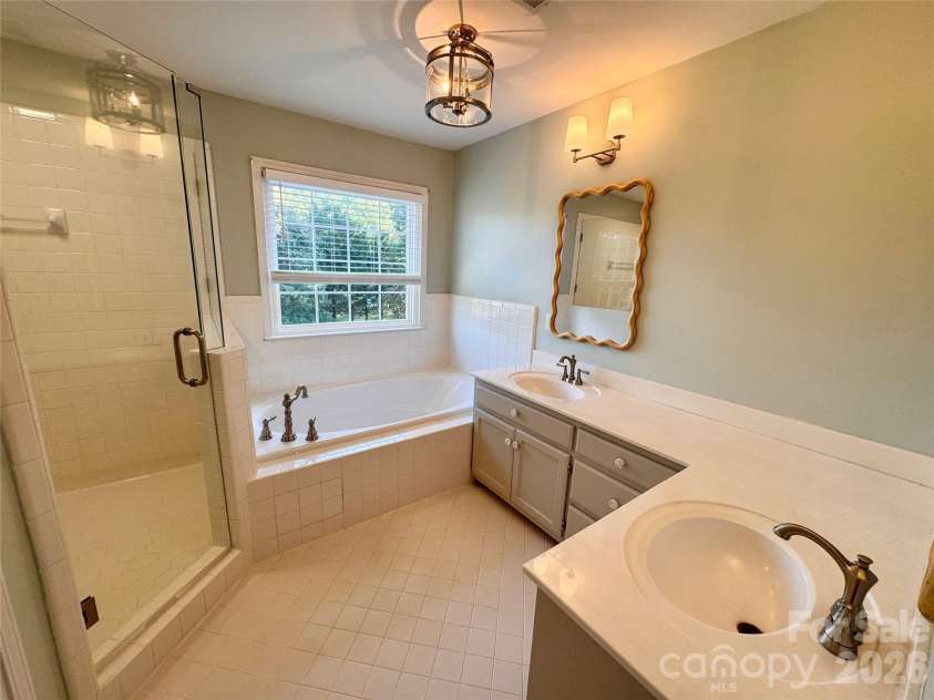 7101 Founders Way, Harris, NC 28075.  MLS# CAR4435546, YatesRealty ID 57347. Primary Bathroom with walk in tiled shower, double vanity with lots of countertop space, and separate water closet.